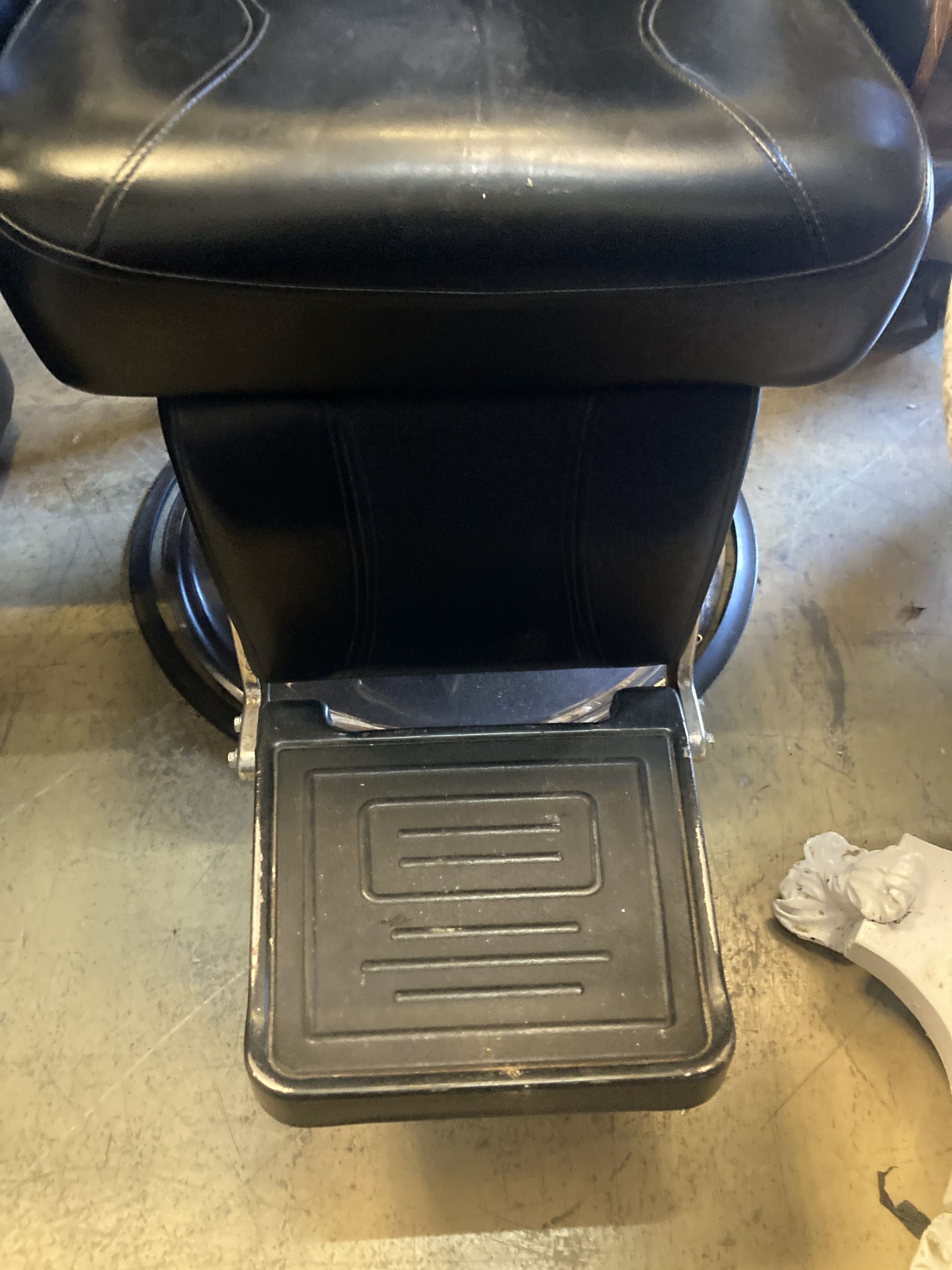 A black leatherette adjustable barbers chair, width 70cm, height 120cm